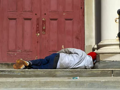 A man sleeps on the steps of a church in Detroit.