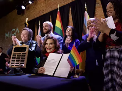 Gov. Gretchen Whitmer signs a bill expanding the state's civil rights act to protect LGBTQ people.