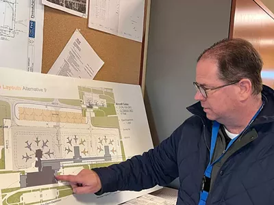 Kevin Klein, CEO of Cherry Capital Airport, points to a graphic of the new terminal design in November of 2024.