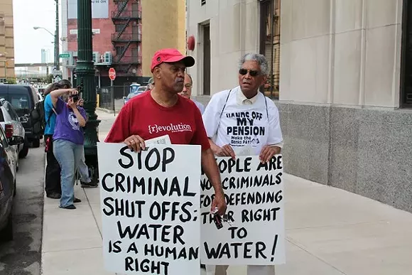 A coalition of welfare rights groups rally outside of the Detroit Water & Sewerage Department's main office at 735 W. Randolph in downtown Detroit on Friday, June 6. The groups were protesting efforts by the city to cut water service to residential customers with $150 or more in outstanding fees. - Ryan Felton/Metro Times