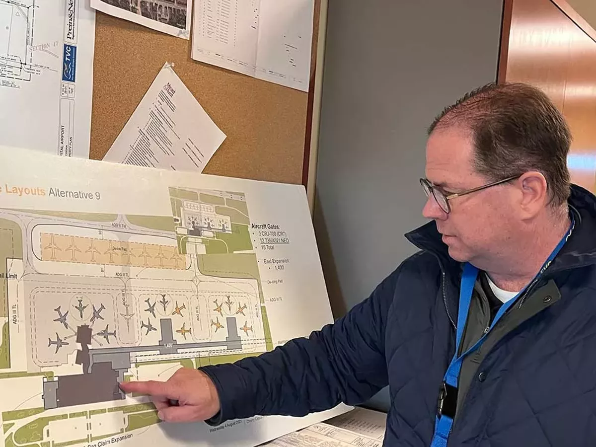 Image: Kevin Klein, CEO of Cherry Capital Airport, points to a graphic of the new terminal design in November of 2024.