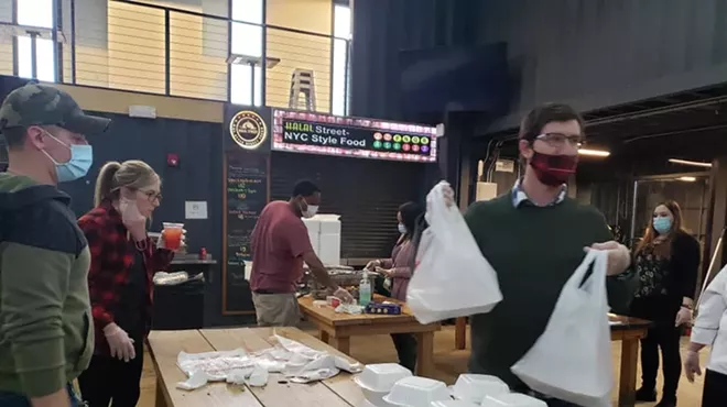 Volunteers help give away chef-made meals for the needy at the Detroit Shipping Co. in 2020.