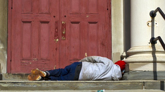 A man sleeps on the steps of a church in Detroit.