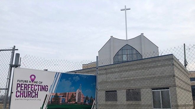 A sign at Detroit’s 18-year Perfecting Church development shows expectations versus reality.