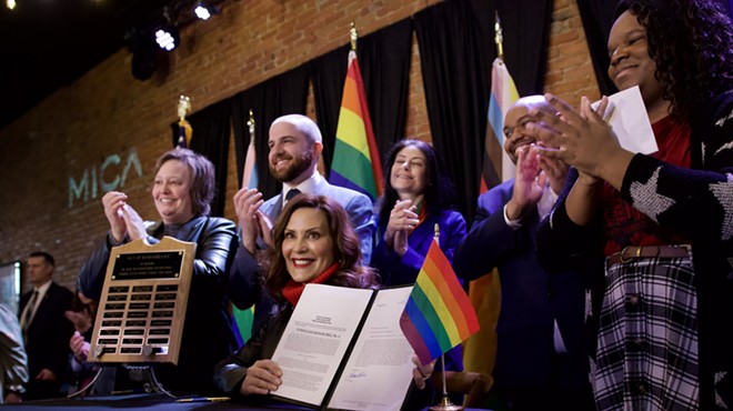 Gov. Gretchen Whitmer signs a bill expanding the state's civil rights act to protect LGBTQ people.