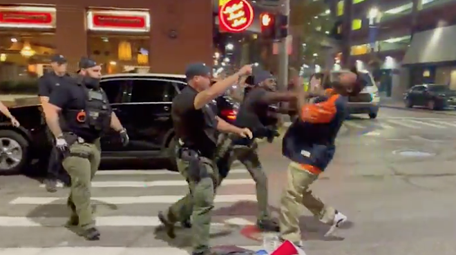 Screenshot of video showing a Detroit cop punching a man in the face in Greektown.