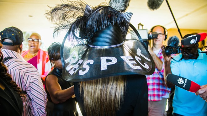 A mourner wears a hat emblazoned with the message “RESPECT” at Aretha Franklin’s funeral.
