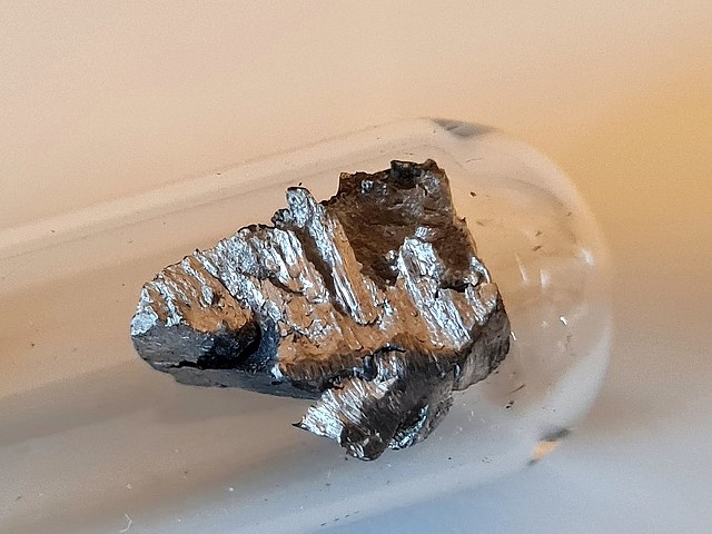 Elemental neodymium, a rare earth metal.