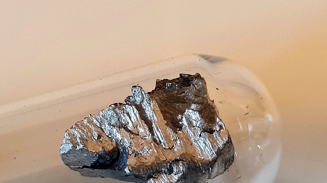 Elemental neodymium, a rare earth metal.