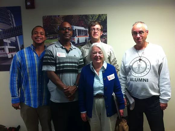 A group of metro Detroit residents wearing “Bring Back the Buses” stickers attended a meeting of the Suburban Mobility Authority for Regional Transportation’s board of directors on Sept. 25, 2014, to ask for more frequent service along Woodward Avenue. - Ryan Felton/Metro Times