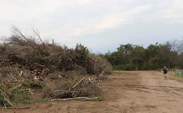 Lindsey Walker, with Emmet County Recycling, walks around one of the county's debris drop-off sites on April 25, 2025