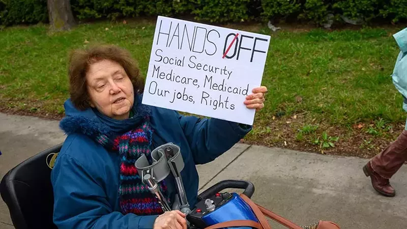 Metro Detroiters protest President Donald Trump as part of a nationwide “Hands Off!” day of action.