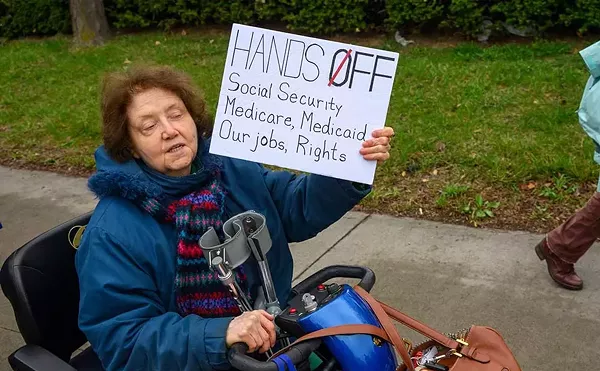 Metro Detroiters protest President Donald Trump as part of a nationwide “Hands Off!” day of action.