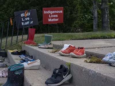 Shoes and toys at a memorial by a Catholic church in Toronto in tribute to 215 indigenous children whose remains were found in a school in Kamloops, British Columbia.