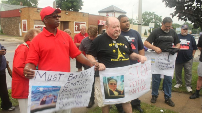 Photo cutline: Representatives from the Detroit Eviction Defense and Detroit Residents protested outside a Singapore-based real estate firm’s office in Pontiac on July 24, 2013, arguing for certain home listings to be removed. (Courtesy Detroit Eviction Defense)