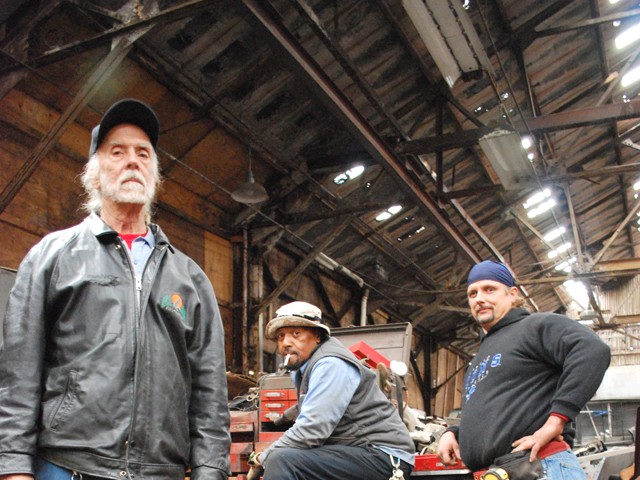 Minister Allan, Mechanic Greg and Carpenter Jeff inside their home at the Packard Plant.