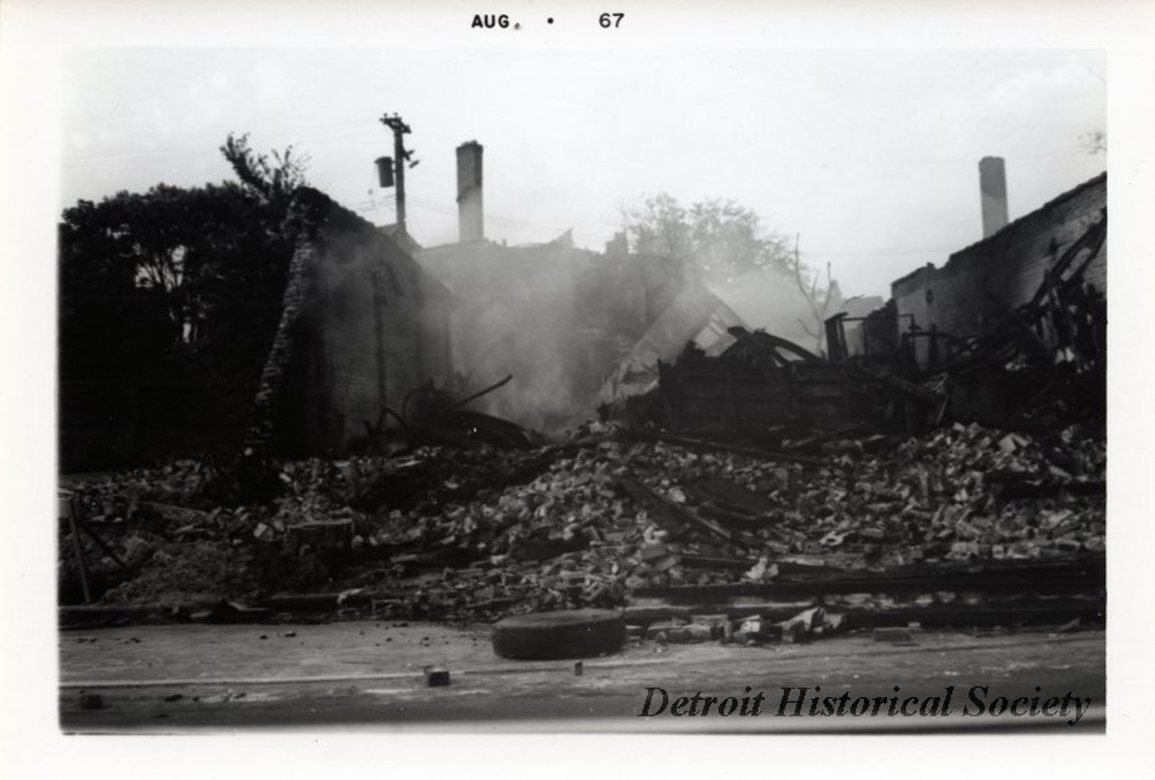 "One digital scan of a black and white photograph which shows the smoldering ruins of several buildings that were destroyed by fire during the 1967 Detroit Riot."