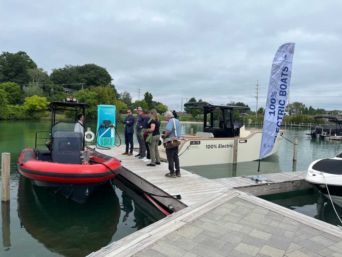 People gather to look at an electric boat during a demo in Elk Rapids in August 2023. Technologies like electric vehicles require critical minerals.