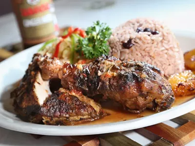 Jerk Chicken with sides of cabbage, peas and rice, and plantains from Jamaican Paradise in Oak Park.