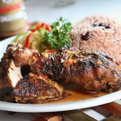 Jerk Chicken with sides of cabbage, peas and rice, and plantains from Jamaican Paradise in Oak Park.