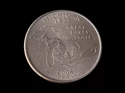 A quarter emblazoned with an image of Michigan.