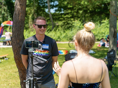 Macomb County Pride President Phil Gilchrist completing an interview during a Pride Picnic in Sterling Heights, June 2021.