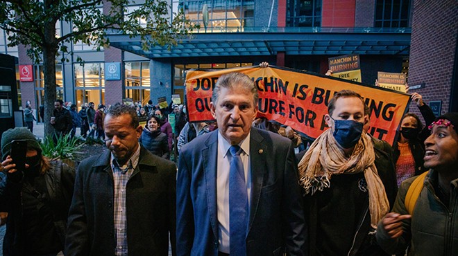 Sen. Joe Manchin confronted by climate activists on his way to Capitol Hill. 