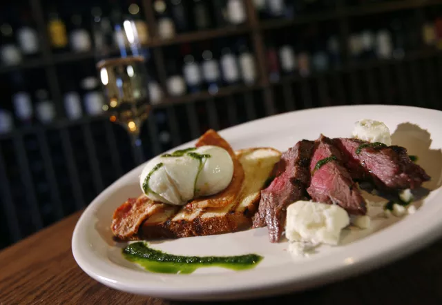 The Amherst Egg: A poached egg and flank steak on brioche with blue cheese and bacon, from Cork Wine Pub in Pleasant Ridge. - MT Photo: Rob Widdis
