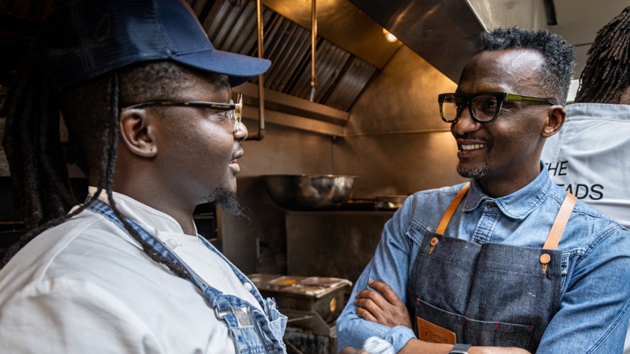 Hamissi Mamba (right) talking to Chef Masai May (left), a former cook at Baobab Fare who is now chef de cuisine of Hamilton’s in Corktown.