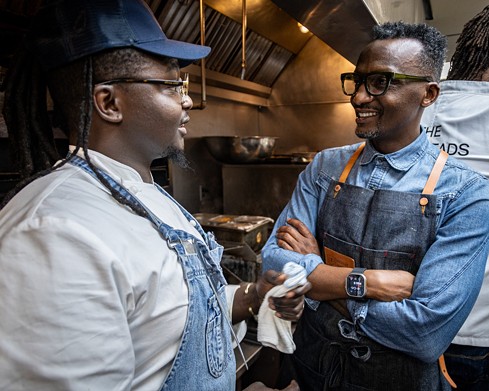 Hamissi Mamba (right) talking to Chef Masai May (left), a former cook at Baobab Fare who is now chef de cuisine of Hamilton’s in Corktown.