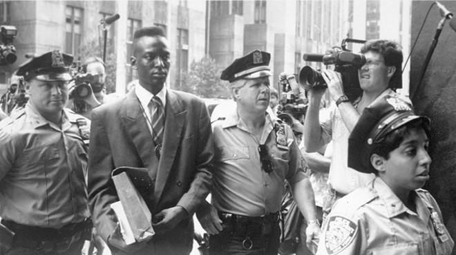 Defendant Yusef Salaam being escorted by police in 1990. The media circus was part of the problem.