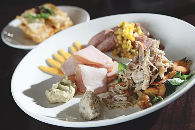 The Root's charcuterie plate: Smoked andouille sausage, pheasant confit salad, rabbit rillette, pork loin and house-made crostini.