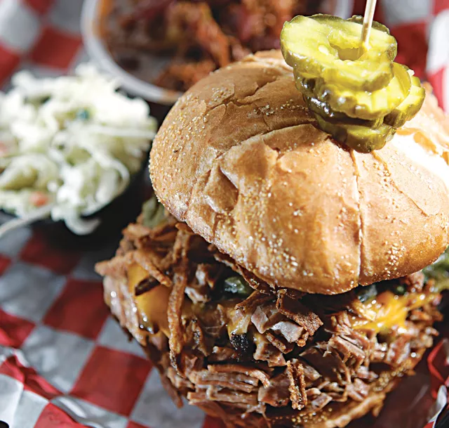 The Smokin' Cowboy Sandwich (chopped beef brisket, fried onions, roasted ancho chiles and cheddar cheese from Smokin' BBQ in Clinton Township