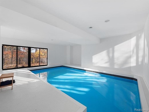 This $1.09M Irving Tobocman-designed masterpiece in West Bloomfield has an indoor pool