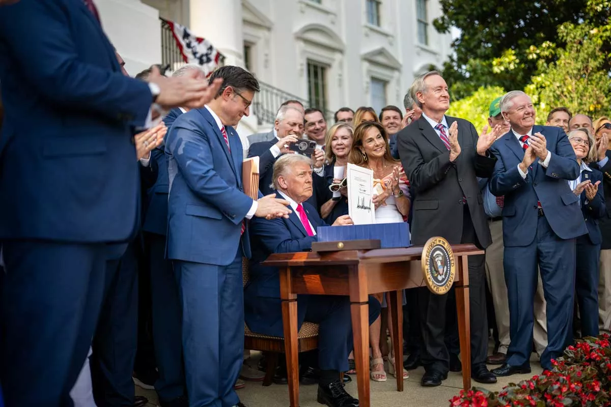 Image: President Donald Trump signs the One Big Beautiful Bill Act on the South Lawn of the White House, Friday, July 4, 2025, during the 4th of July picnic.