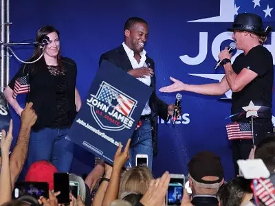 John James, center, who ran for U.S. Senate, was endorsed by Kid Rock, right, who didn't run for Senate but pretended to.