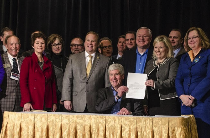 Gov. Rick Snyder signing a bill appropriating $28 million in short-term aid for the people of Flint in January 2016. - PHOTO COURTESY GOV. SNYDER'S OFFICE