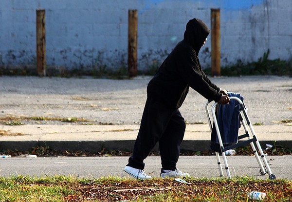 A man pushes a broken walker down Peterboro Street in Detroit. - Jeff Smith, Flickr