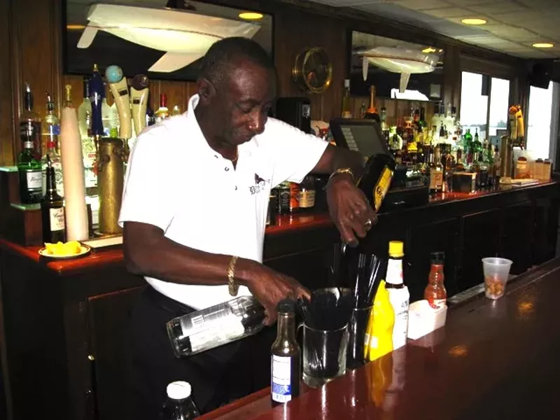 Jerome Adams mixing his signature drink behind the bar at Bayview Yacht Club in 2011. - Photo by Michael Jackman