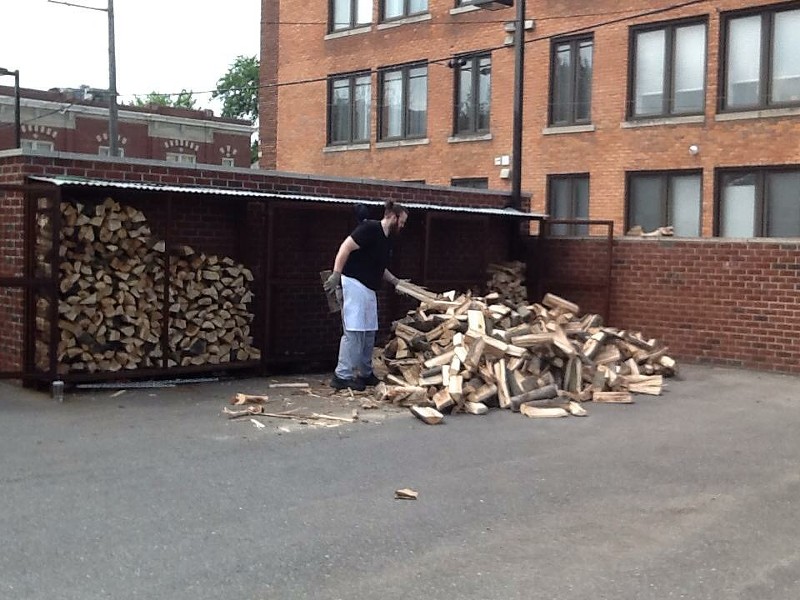 John chopping wood for the smoker at Slow's. - Courtesy photo