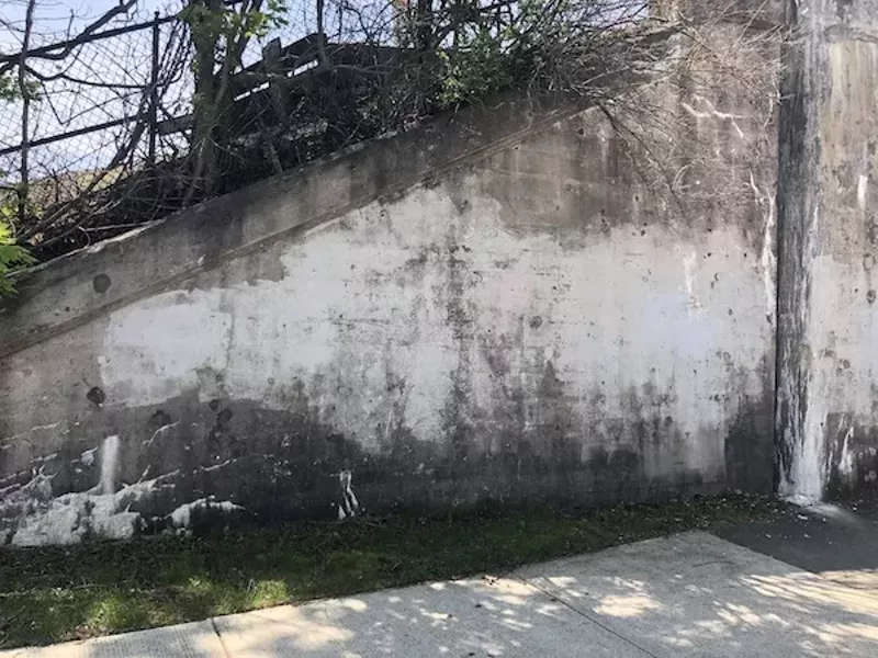 Oxley says he painted the mural to beautify the viaduct wall, shown here before his artwork went up. - PHOTO COURTESY CARL OXLEY