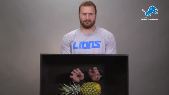 Detroit Lions Center Frank Ragnow is petrified by a pineapple. - Photo via Detroit Lions Twitter account