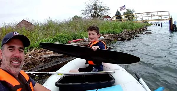 Father and son fish for trash in Detroit River