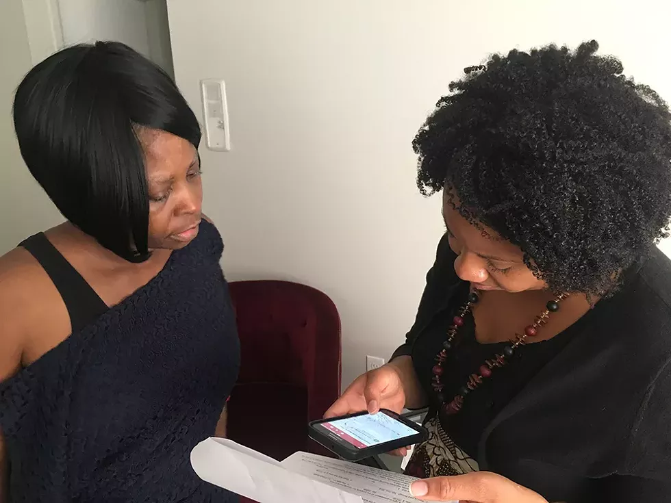 McGee and a housing adviser go over her lease agreement after McGee is served with an eviction notice for back rent. - Violet Ikonomova