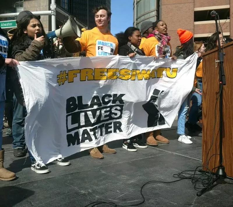 Activists hold a #FreeSiwatu banner at the March for Our Lives rally for gun reform on March 24, 2018 in Detroit. - Courtesy photos