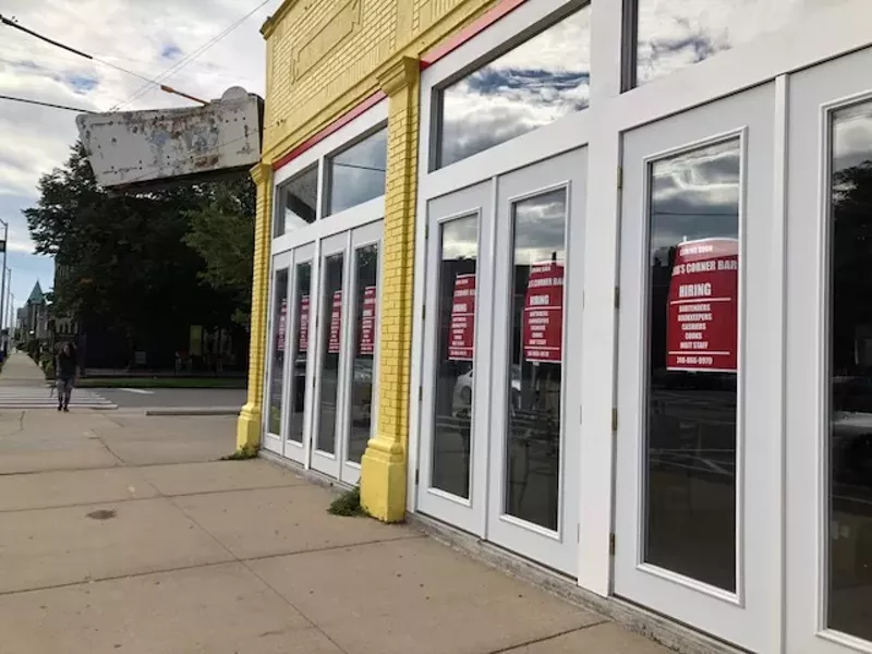 Hiring signs appear in the windows of the long-vacant space at the corner of Willis St. and Cass Ave. - Photo by Devin Culham