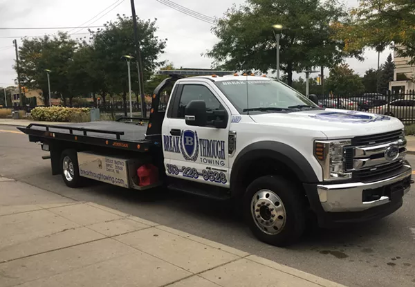 A Breakthrough Towing driver idles on East Canfield, waiting for his next victim. - Violet Ikonomova