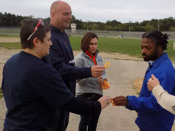 Jason Carr passes out ChadTough bracelets to inmates at Cotton. - Courtesy of ChadTough