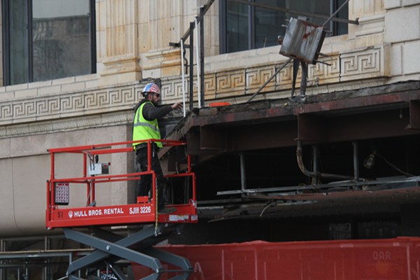 A construction worker removing the final pieces from the historic Fillmore marquee. - WILL FEUER