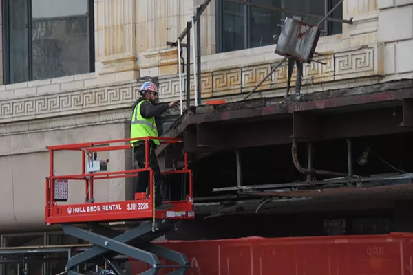 A construction worker removing the final pieces from the historic Fillmore marquee. - Will Feuer